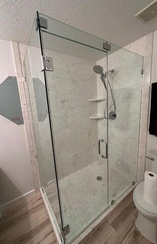 Newly renovated walk-in shower with white walls and modern fixtures