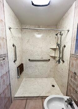 Accessible walk-in shower remodel with white walls and open entry