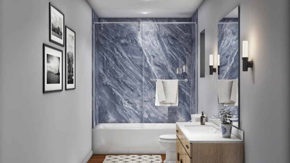 Remodeled bathtub area with blue marble-look wall surround and clean finish